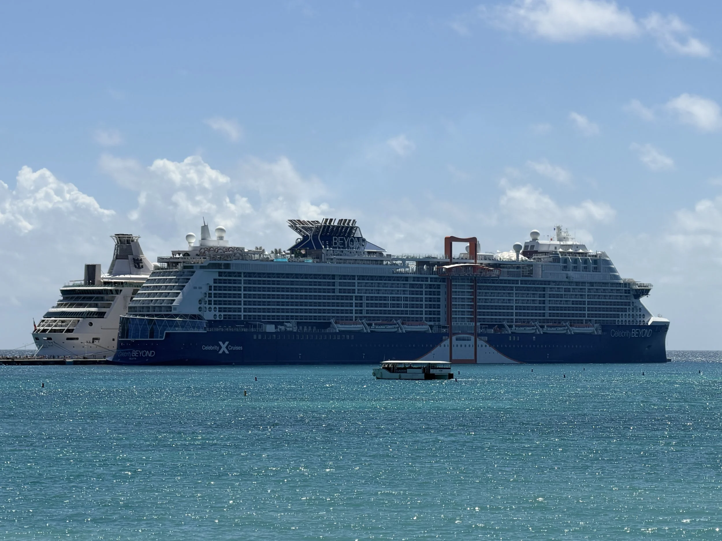 Celebrity Beyond cruise ship anchored in turquoise Caribbean waters