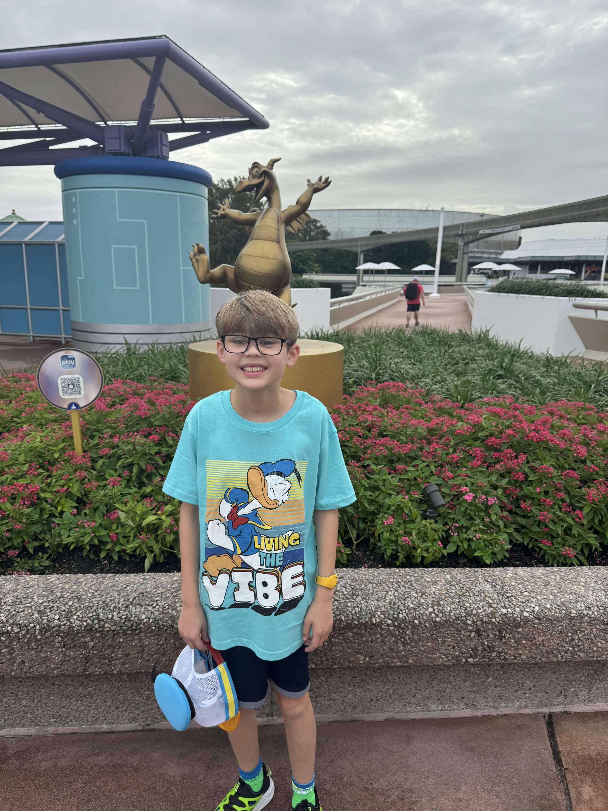 Boy at Disney Cruise Line themed area with character statue