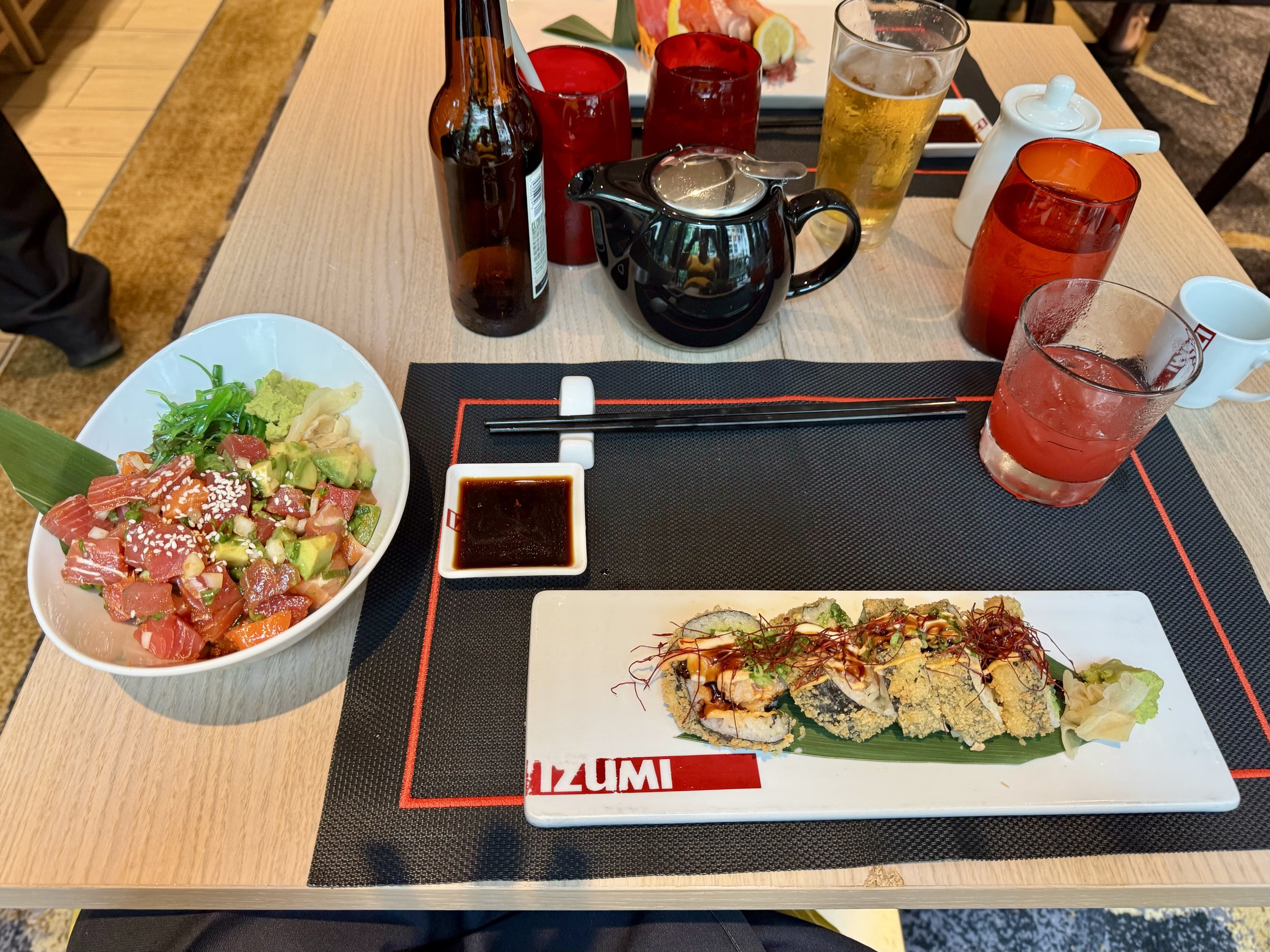 Japanese sushi restaurant meal with nigiri rolls and sashimi bowl