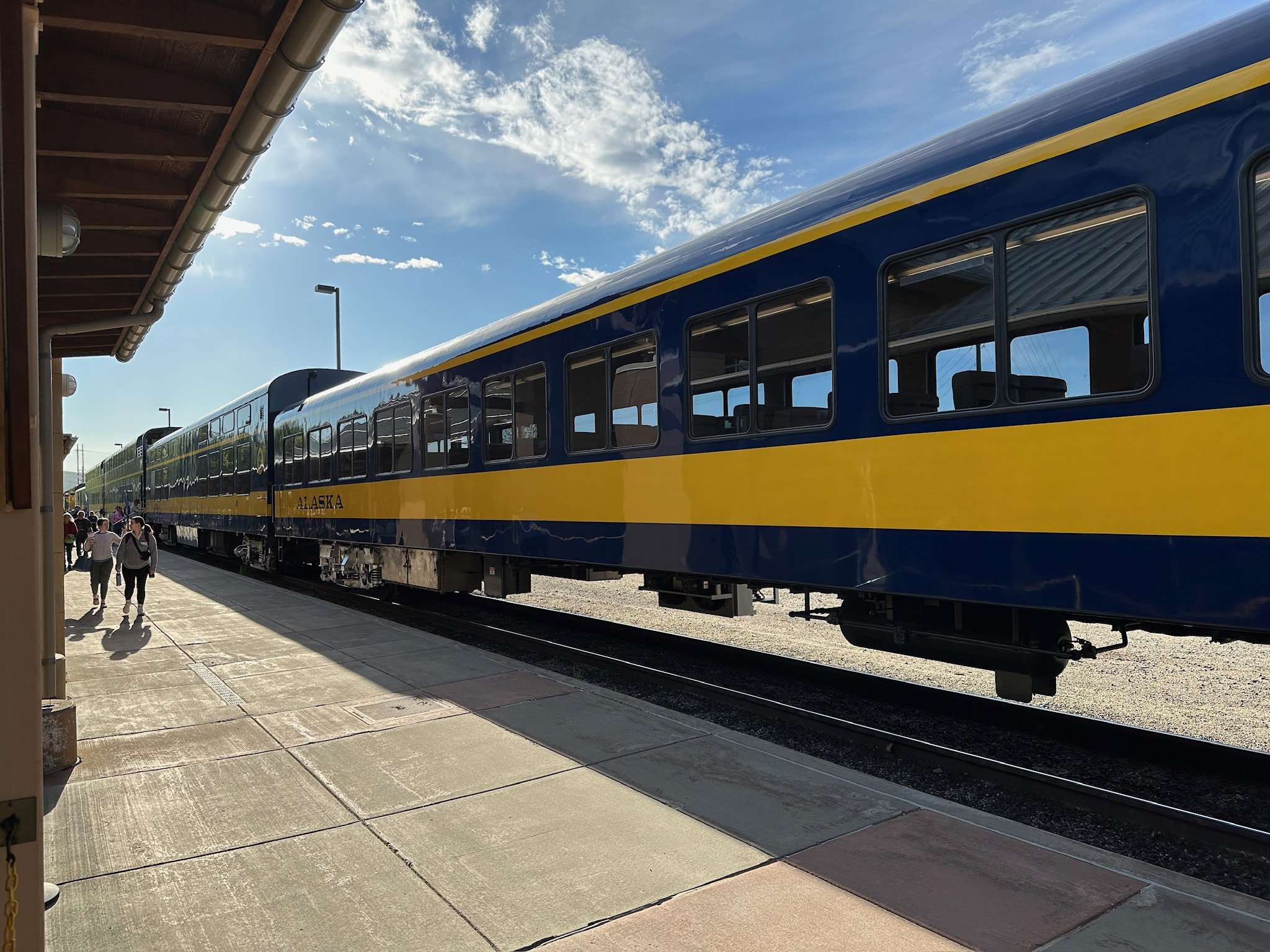 Blue and yellow Alaska train at station platform