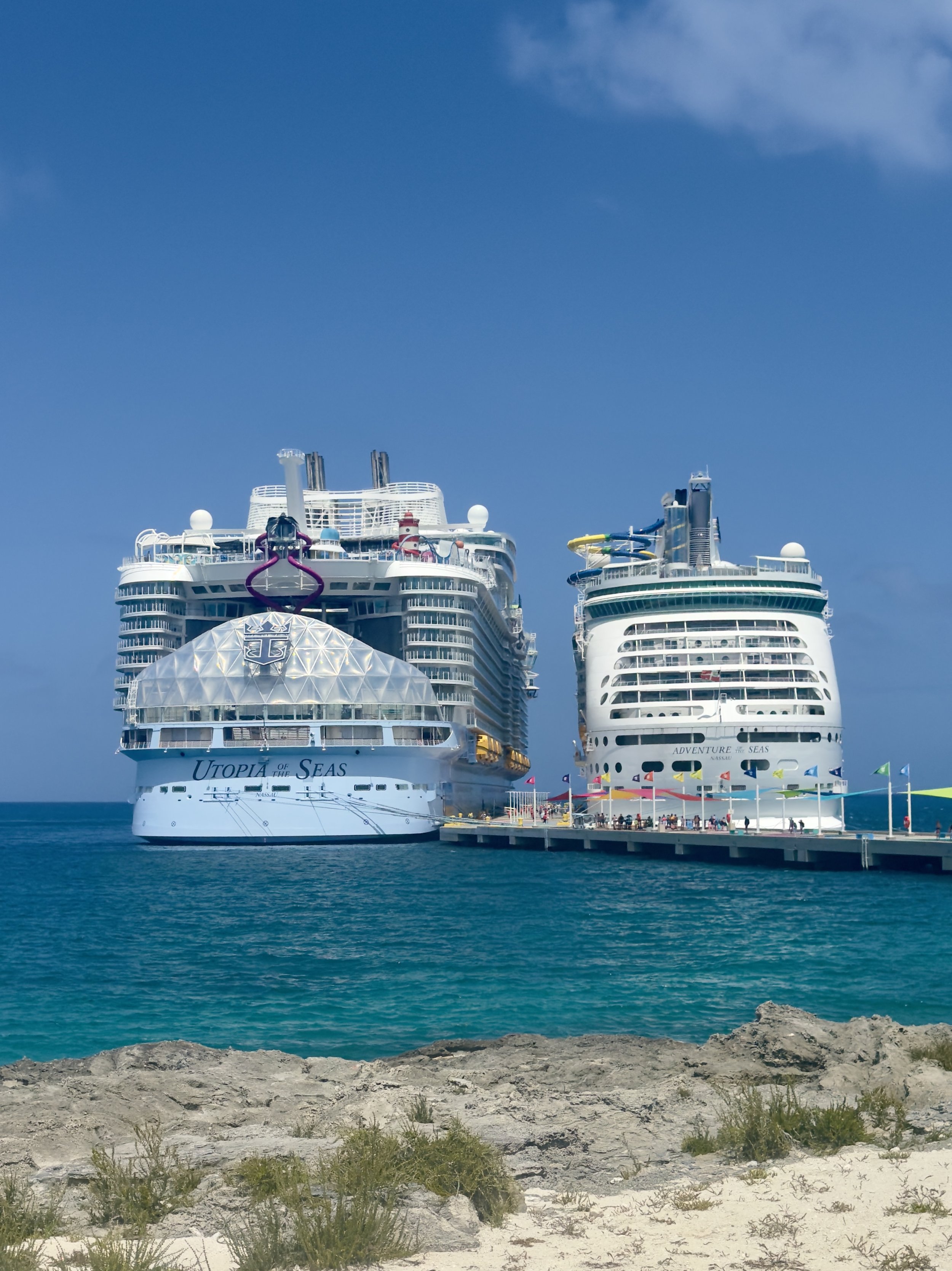 Utopia of the Seas and Adventure of the Seas docked at tropical port