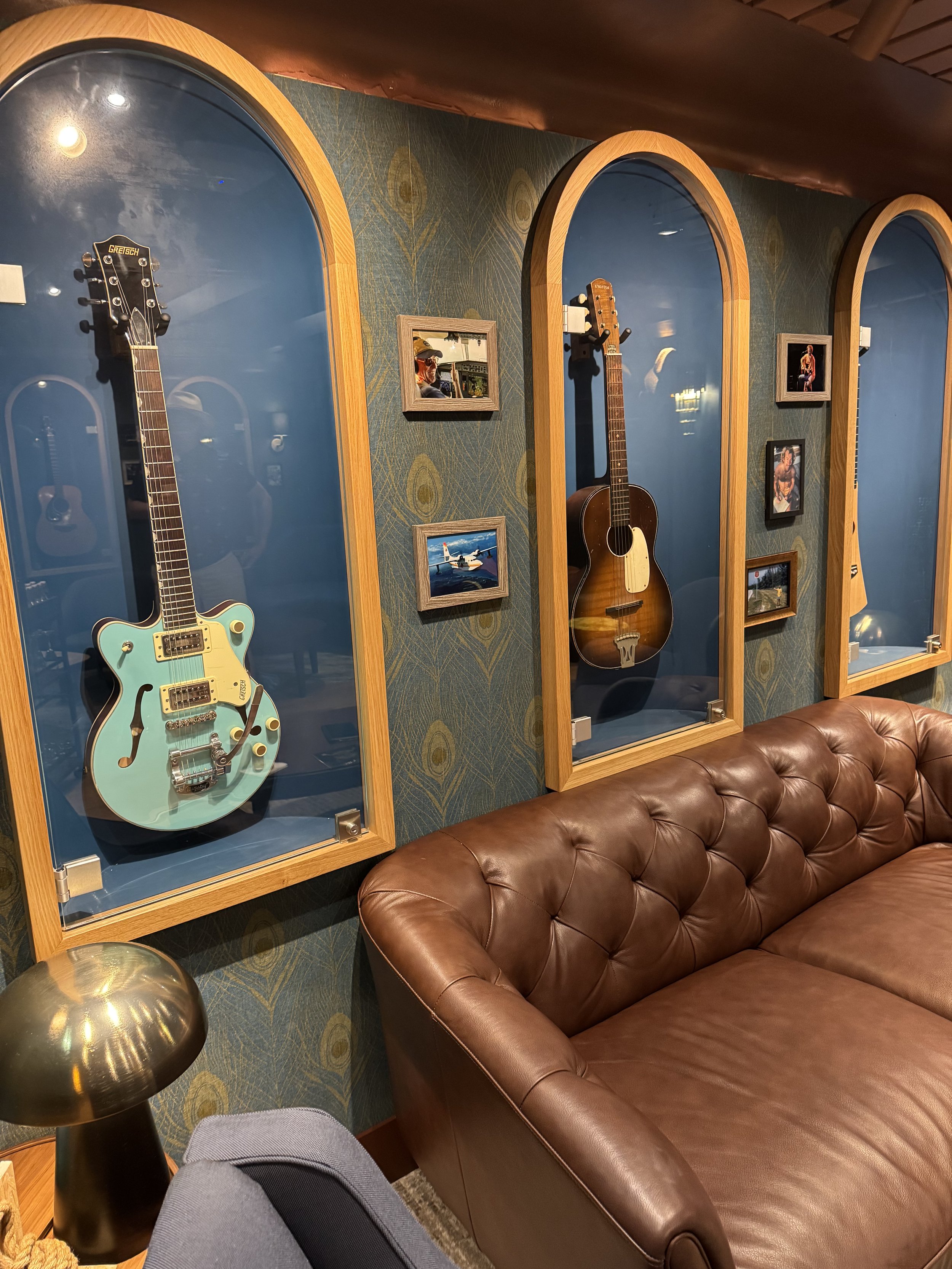 Elegant ship display room showcasing vintage guitars in wooden cases