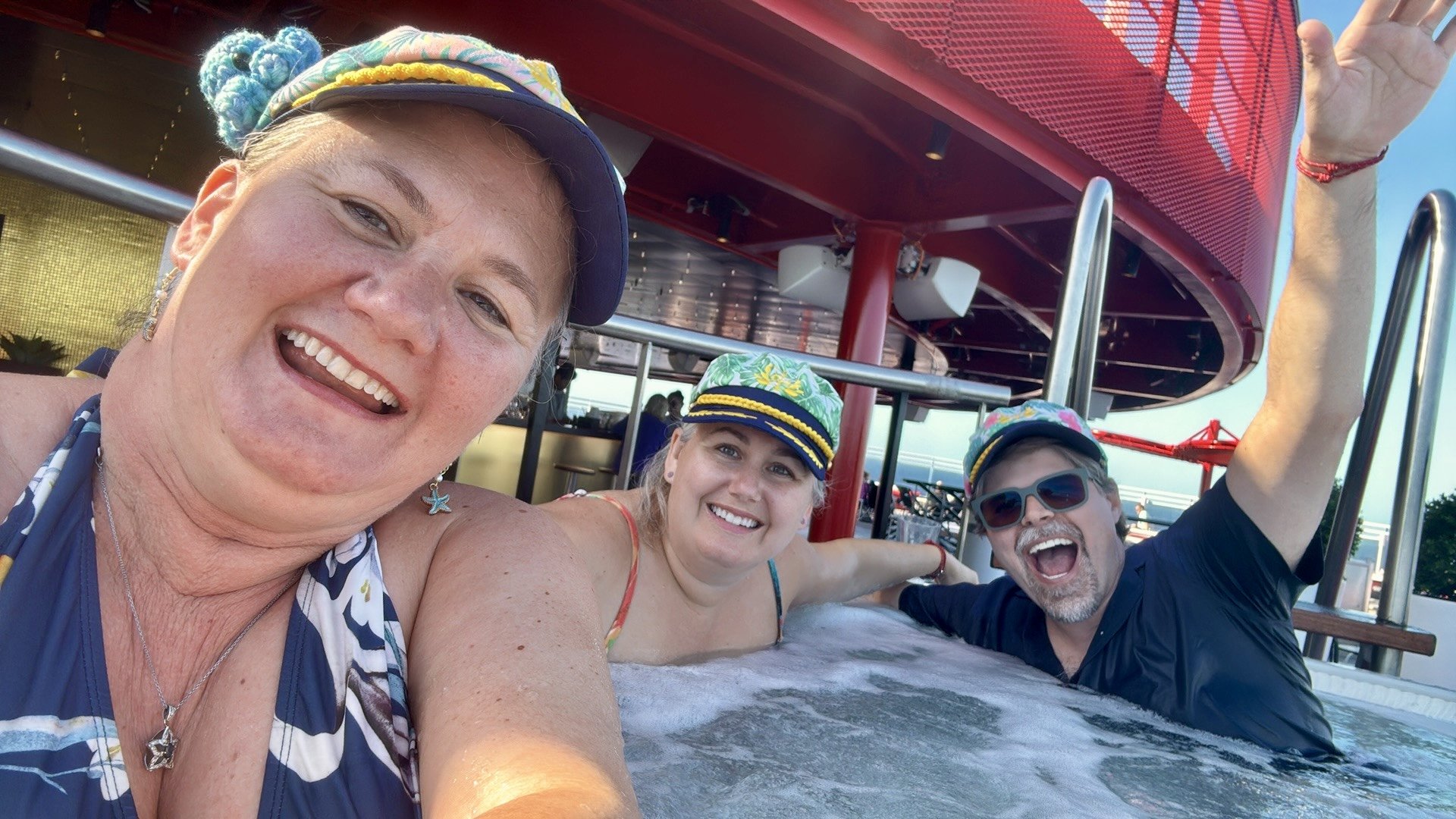 # Group of four smiling cruise passengers enjoying hot tub on ship deck