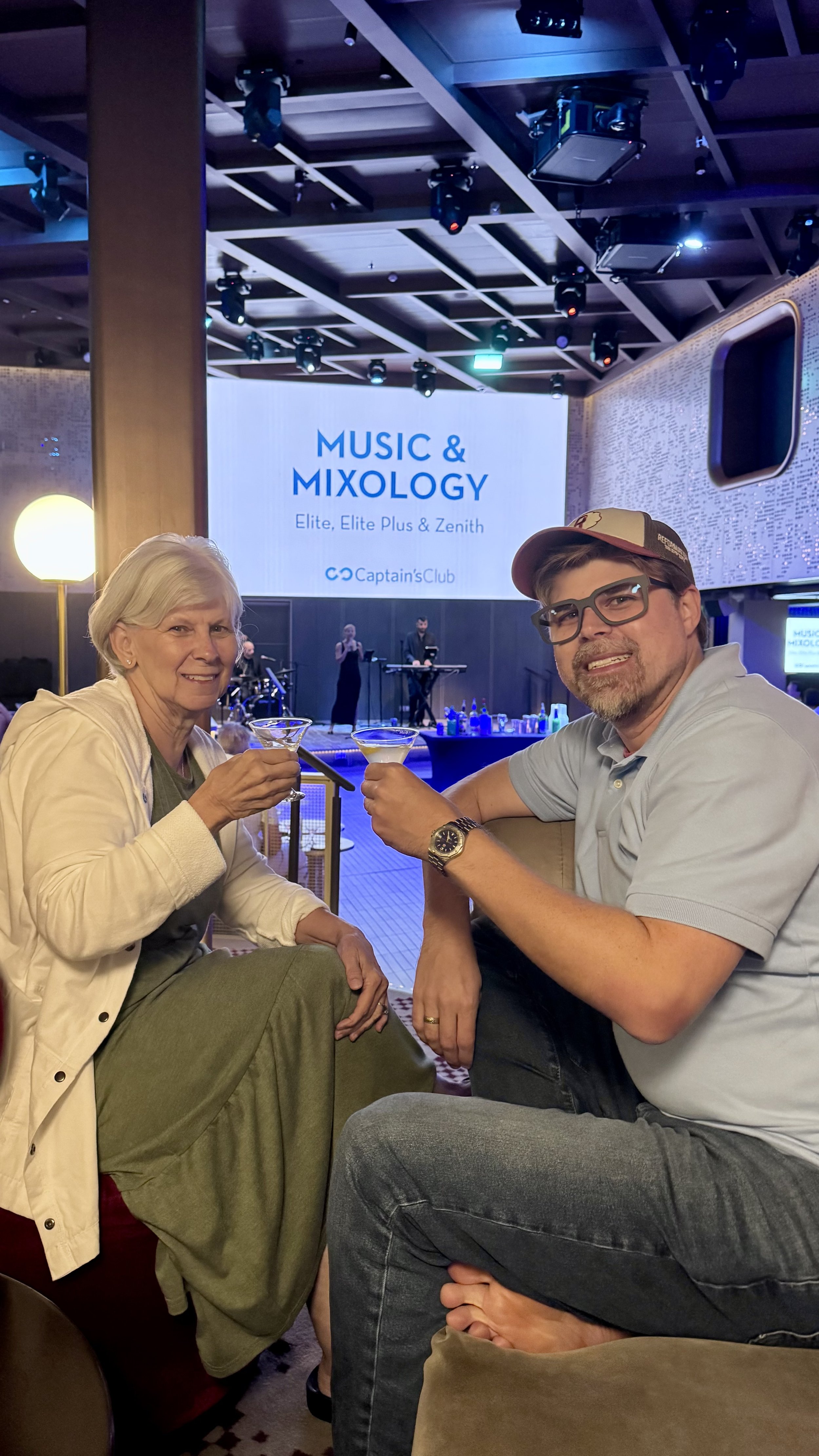 Two passengers toast at Music Mixology event Captain's Club