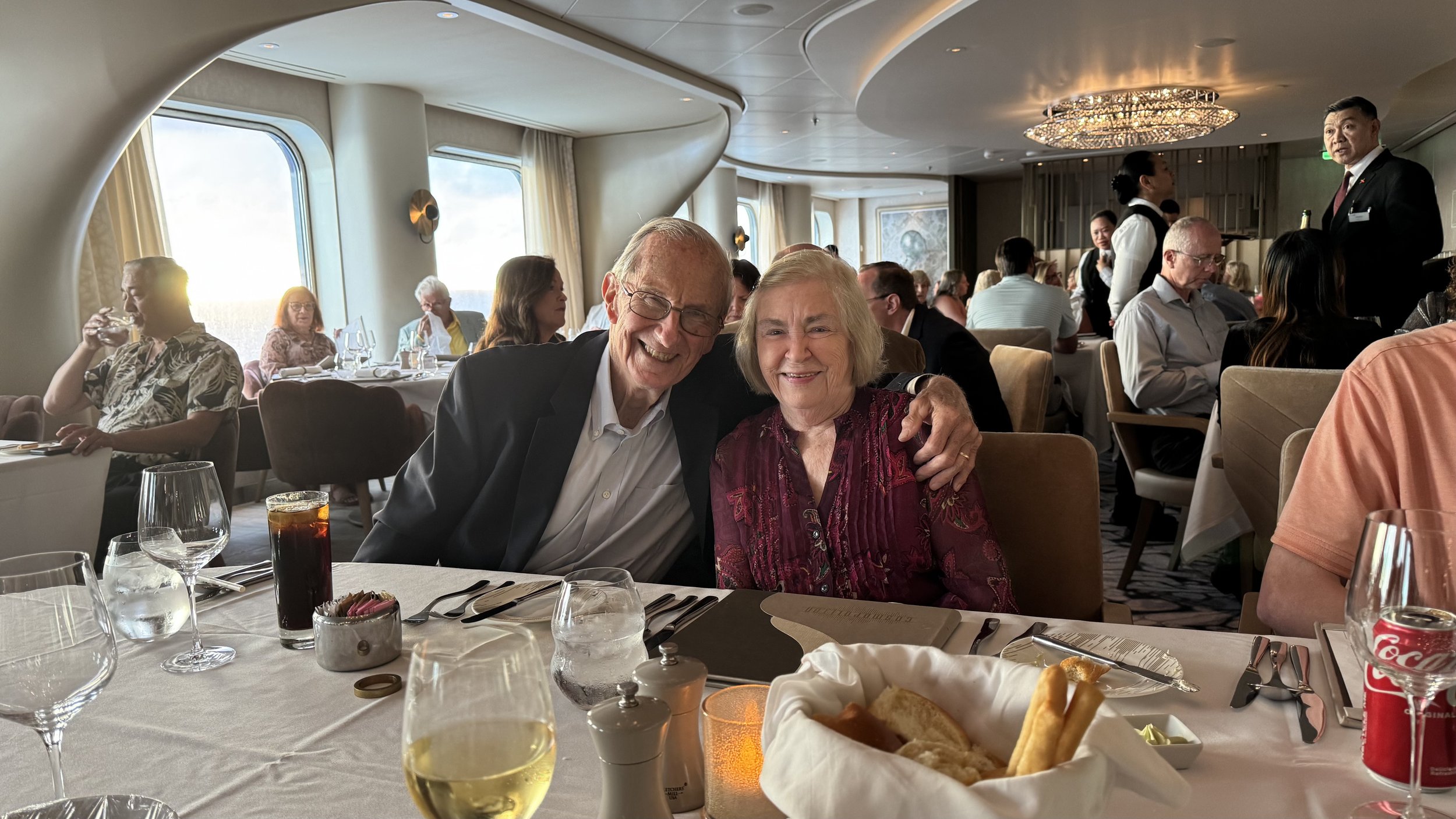 Couple dining together in elegant cruise ship restaurant with ocean view