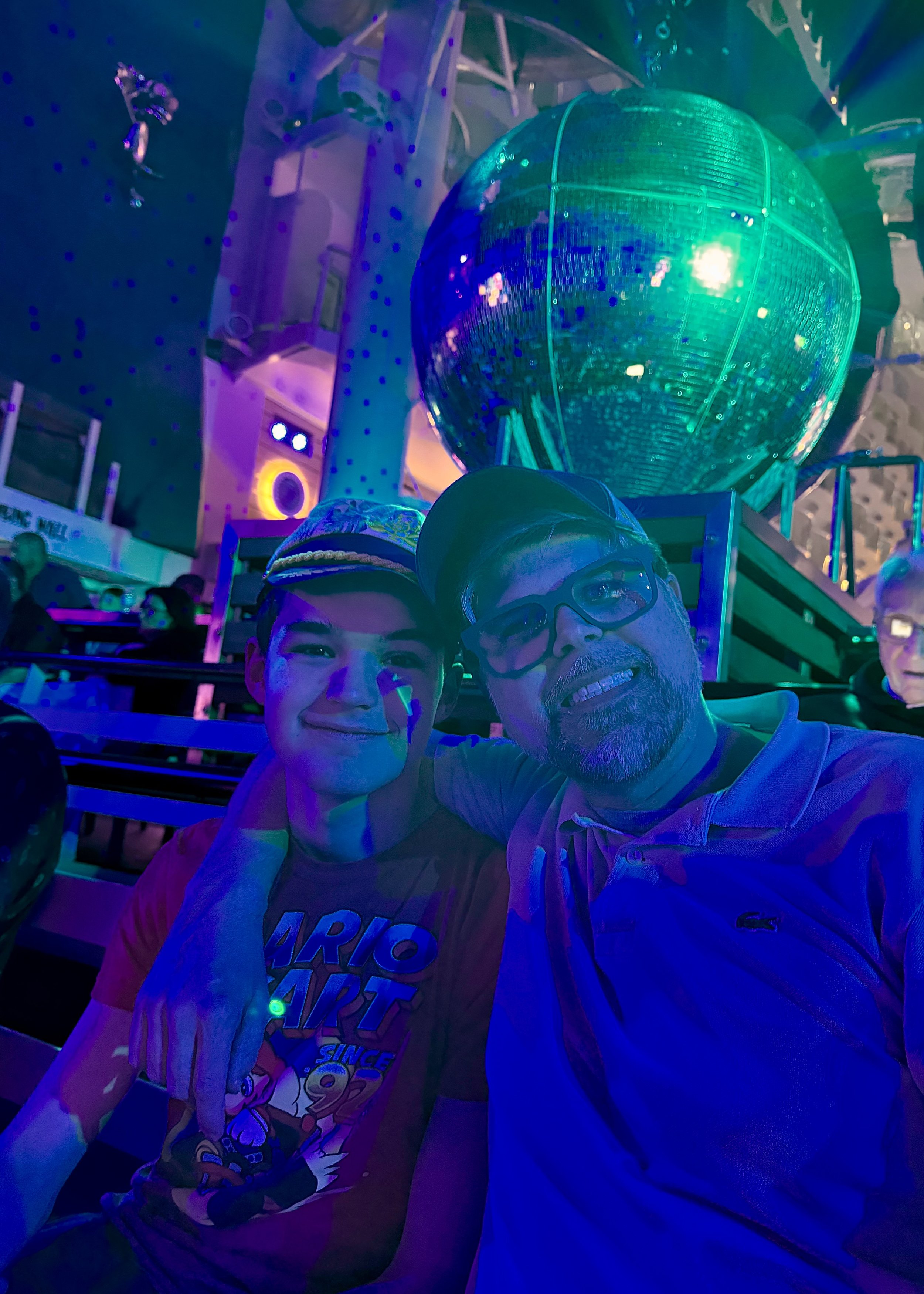 Two guests at disco ball nightclub event on cruise ship