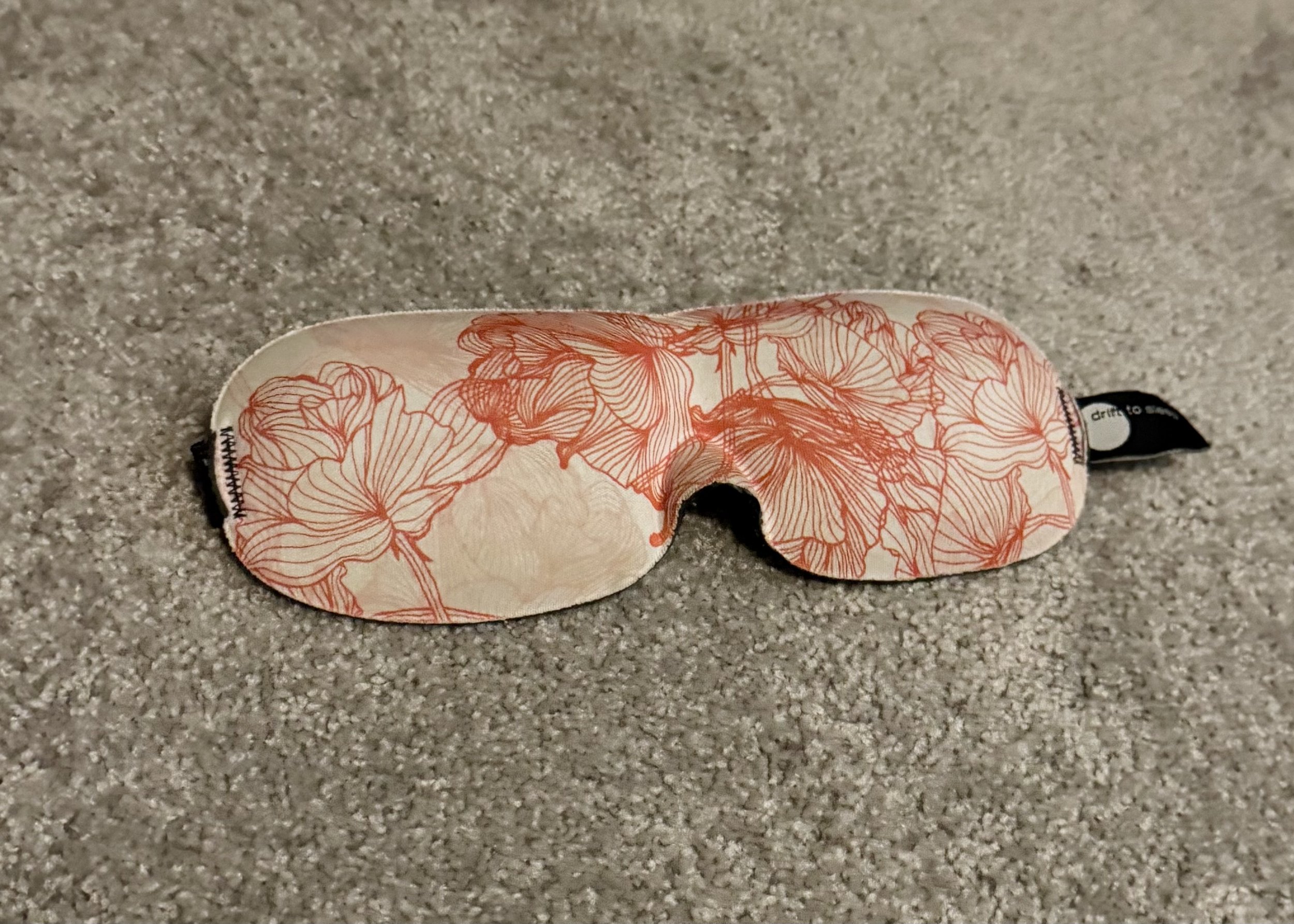 Decorative sleep mask with red floral botanical line art pattern
