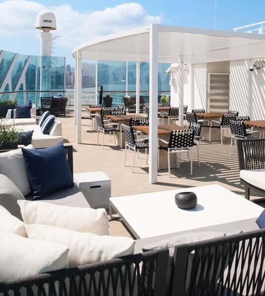 Modern rooftop deck with lounge seating and retractable shade